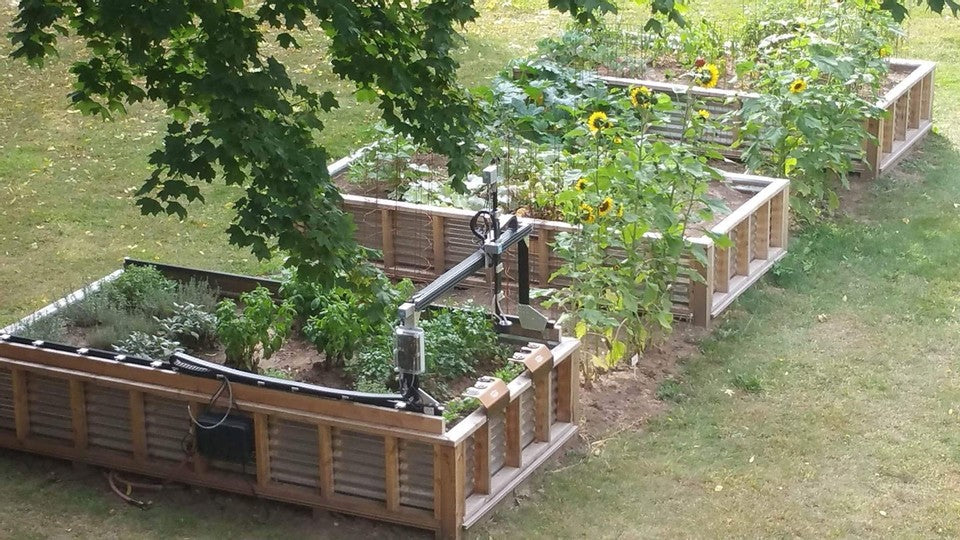 FarmBot gantry system tending raised garden beds